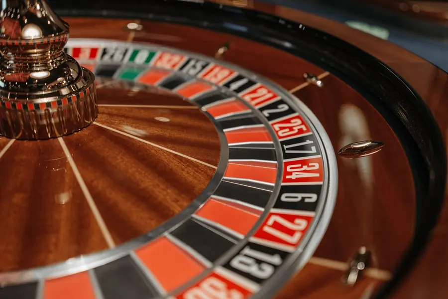 Close-up of a roulette wheel with red and black numbered pockets